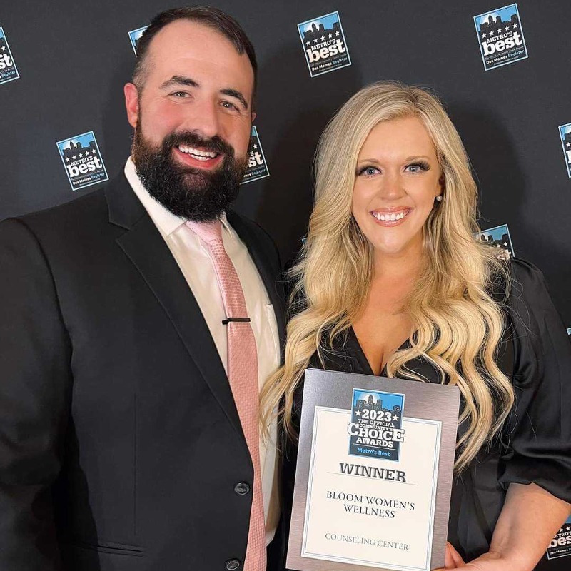 Two people holding up an award