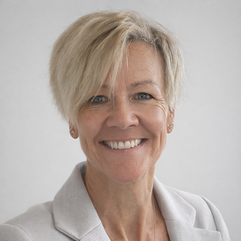 Woman with short blonde hair smiling.